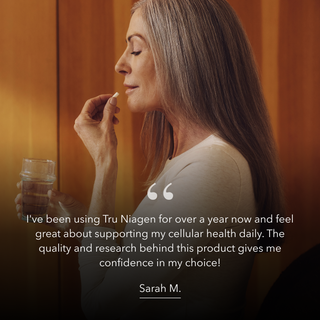 Woman holding a glass of water with a testimonial quote from Sarah M about Tru Niagen that reads: "I've been using Tru Niagen for over a year now and feel great about supporting my cellular health daily. The quality and research behind this products gives me confidence in my choice!"